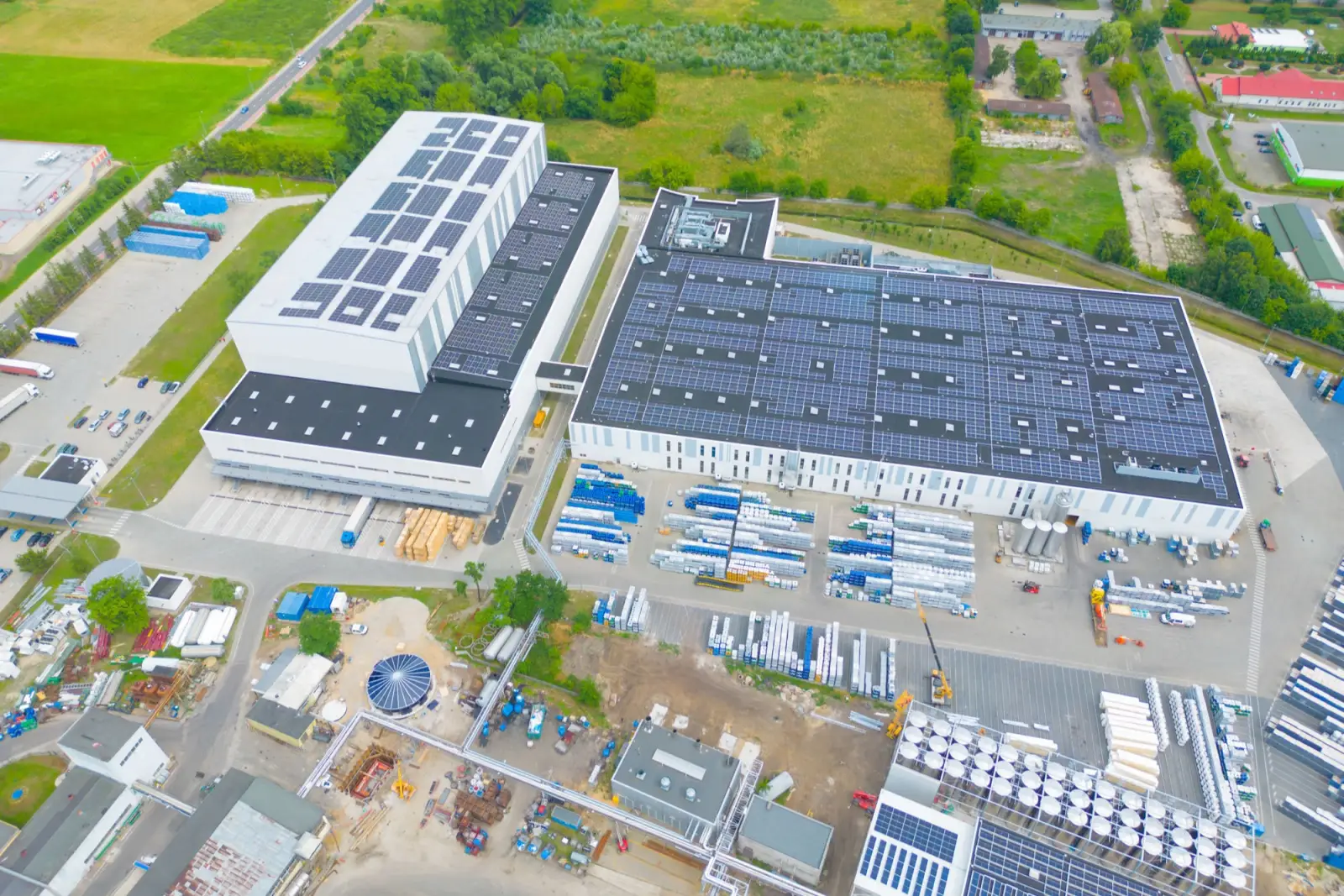 Drone view of an industrial estate with warehouse roofs covered in solar panels